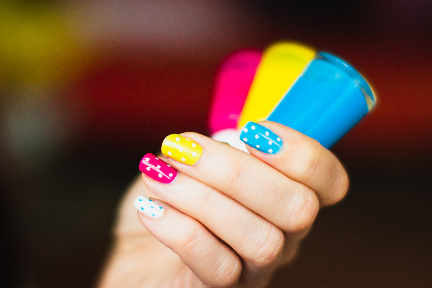 A Person Holding Bottles of Nail Polish